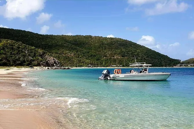 Private BVI power boat anchored near Norman Island caves on a snorkeling in Tortola BVI full-day charter, British Virgin Islands